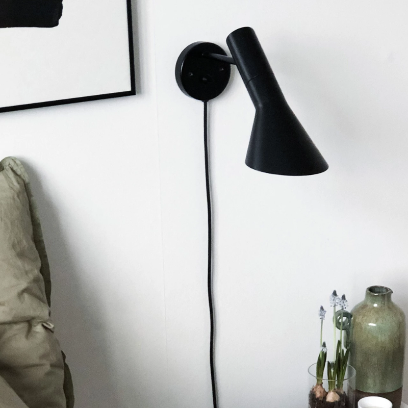 The AJ Wall from Louis Poulsen in a guest room.