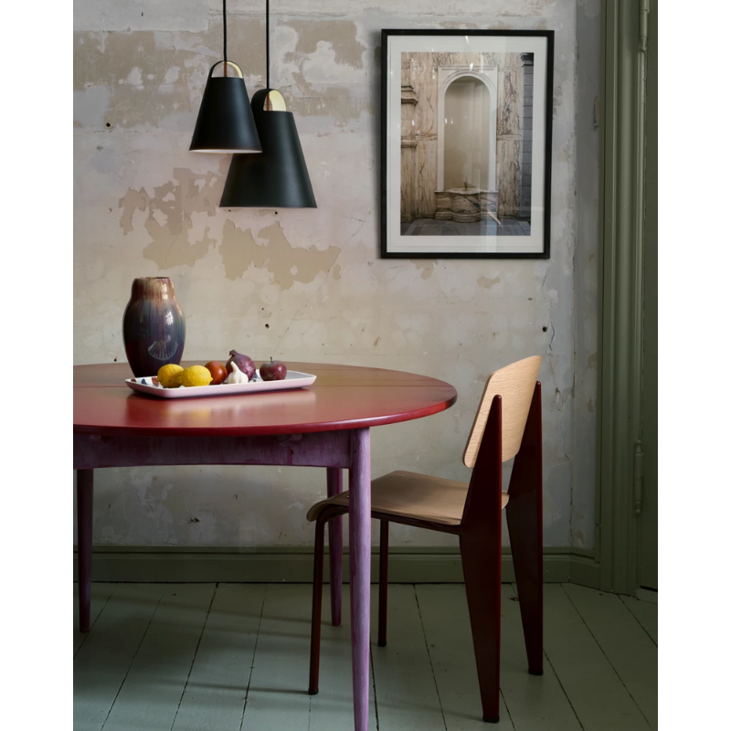 The Above from Louis Poulsen in a dining room.