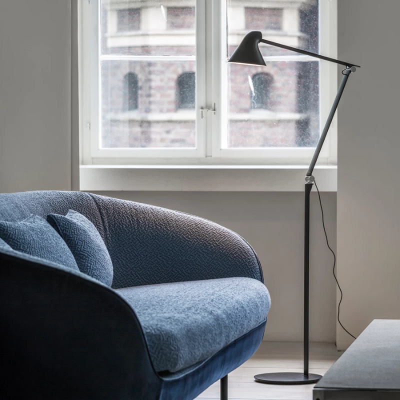 The NJP Floor Lamp from Louis Poulsen in a living room.