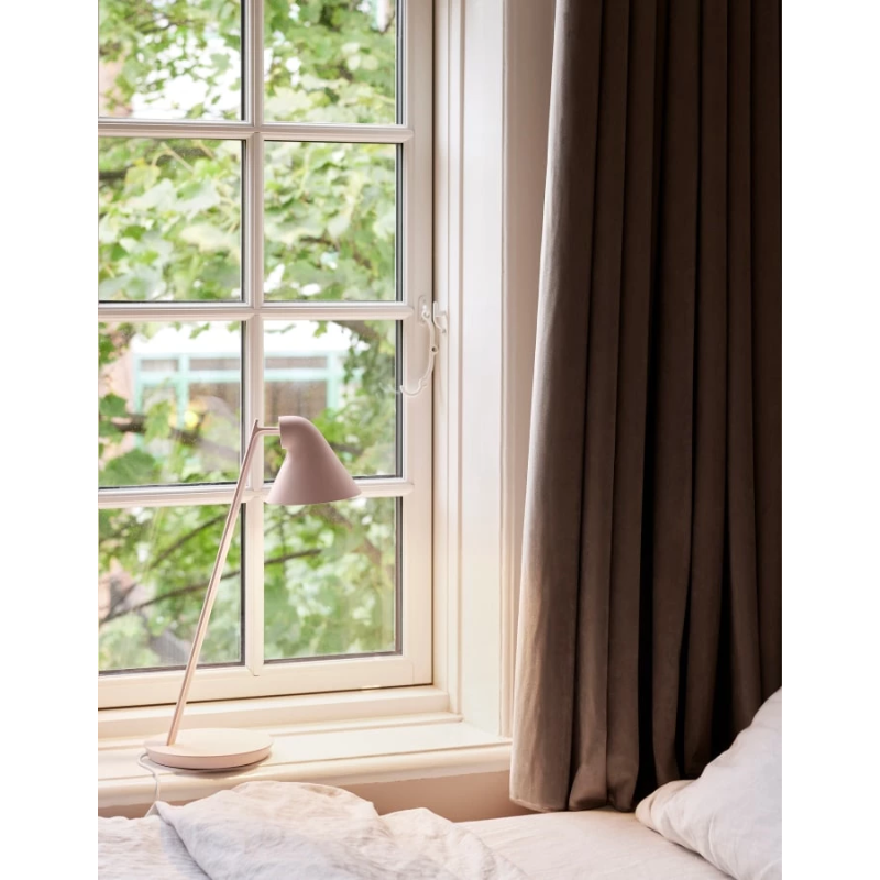 The NJP Mini from Louis Poulsen in a lounge lifestyle photograph.