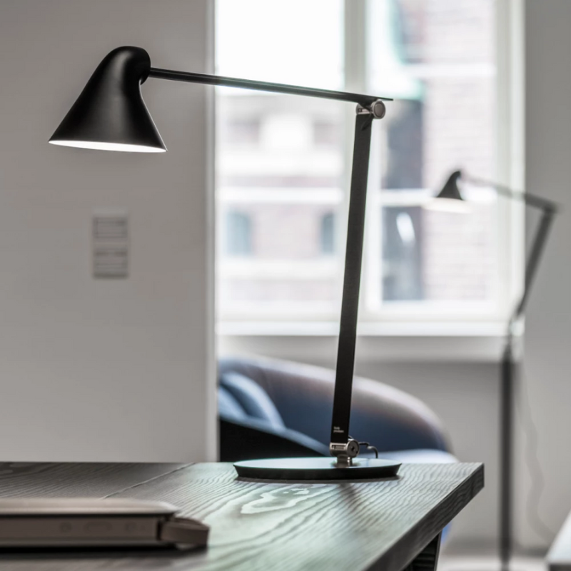 The NJP Table from Louis Poulsen in a living room.