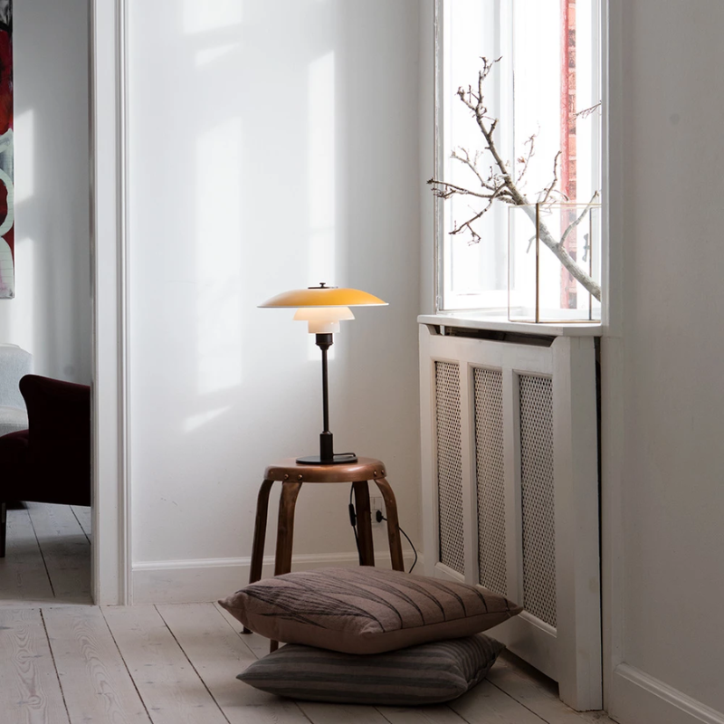 The PH 3½-2½ Table Lamp from Louis Poulsen in living room.