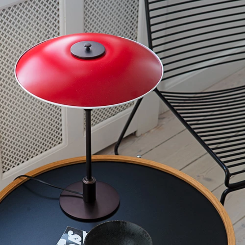 The PH 3½-2½ Table Lamp from Louis Poulsen in a lounge lifestyle shot.