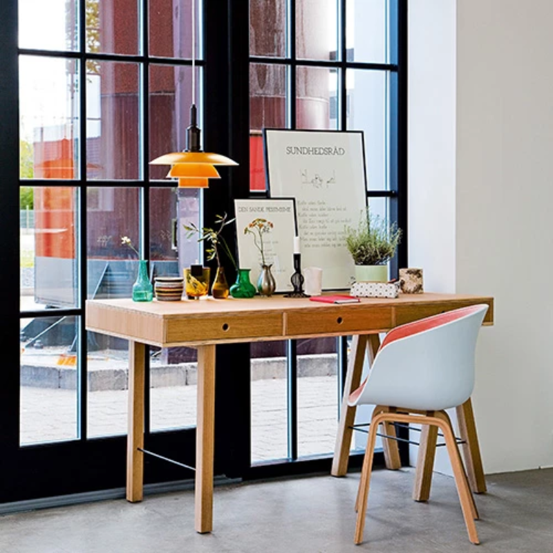 The PH 3½-3 Pendant Light from Louis Poulsen in a home office.