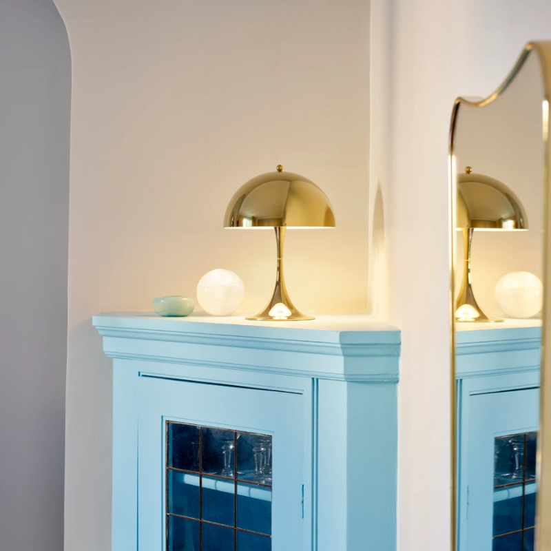 The Panthella 250 Table Lamp from Louis Poulsen in a bedroom.
