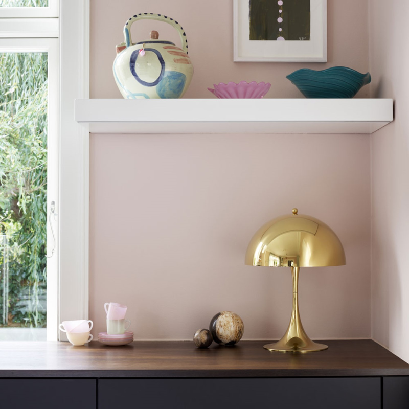 The Panthella 320 Table Lamp from Louis Poulsen in a living room.