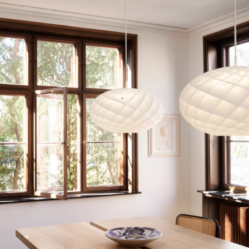 The Patera Oval from Louis Poulsen in a dining room.