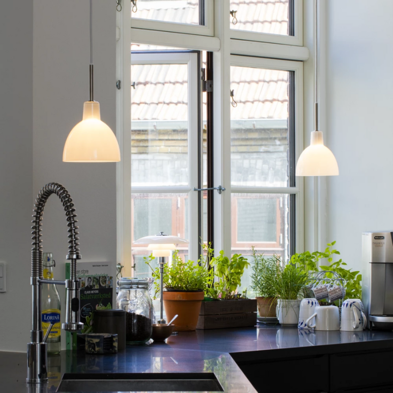 The Tolbod 6.1/8.7 Glass Pendant from Louis Poulsen in a kitchen. all-groups