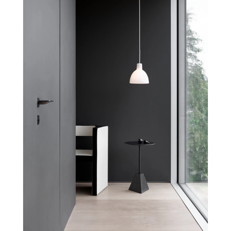 The Tolbod 6.1/8.7 Glass Pendant from Louis Poulsen in a living room.