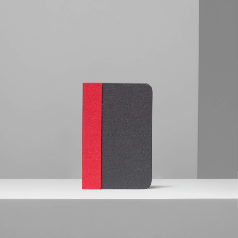 The Lito Mini from Lumio in red and grey within a studio.