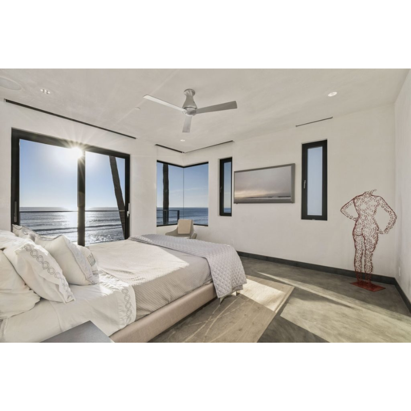The Altus Flush ceiling fan from Modern Fan Co. in a oceanside bedroom.