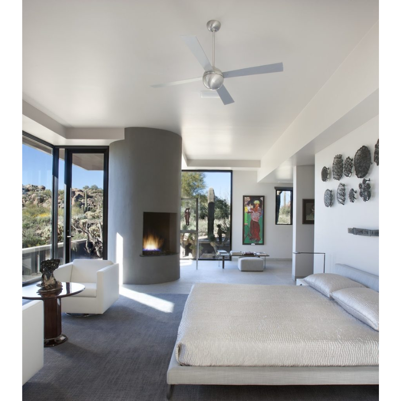 The Ball ceiling fan from The Modern Fan Co. in the bedroom of a desert home.