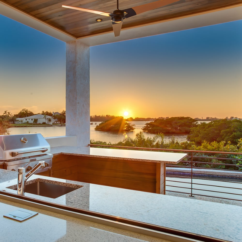 The Torsion 17W LED - 52" ceiling fan from The Modern Fan Co. in an outdoor lifestyle shot.