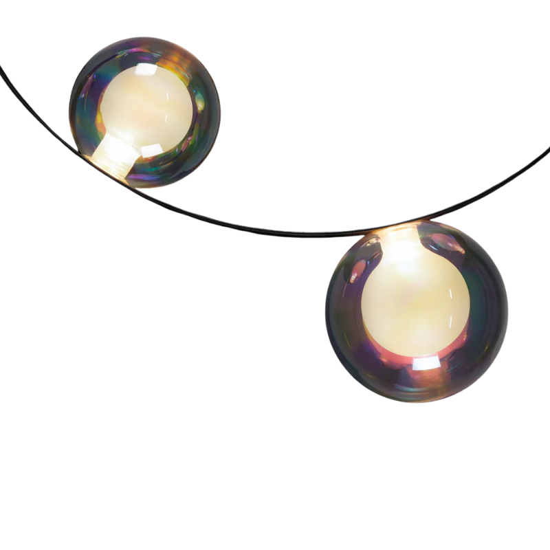 Hubble Bubble, designed by Marcel Wanders, is an airy and joyful suspension lamp. Available in two sizes, with either 7 or 11 glass LED bubbles in oil-iridescent or frosted versions. Hubble Bubble can be hung both horizontally and vertically and is powered through Electrosandwich® by Marcel Wanders. Hubble Bubble is the cheery statement piece in your home that can hang from any angle.