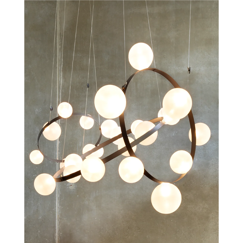 Hubble Bubble, designed by Marcel Wanders, is an airy and joyful suspension lamp. Available in two sizes, with either 7 or 11 glass LED bubbles in oil-iridescent or frosted versions. Hubble Bubble can be hung both horizontally and vertically and is powered through Electrosandwich® by Marcel Wanders. Hubble Bubble is the cheery statement piece in your home that can hang from any angle.