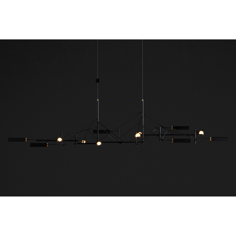 The Tinkering Linear Suspension Light by Moooi in a dark space.