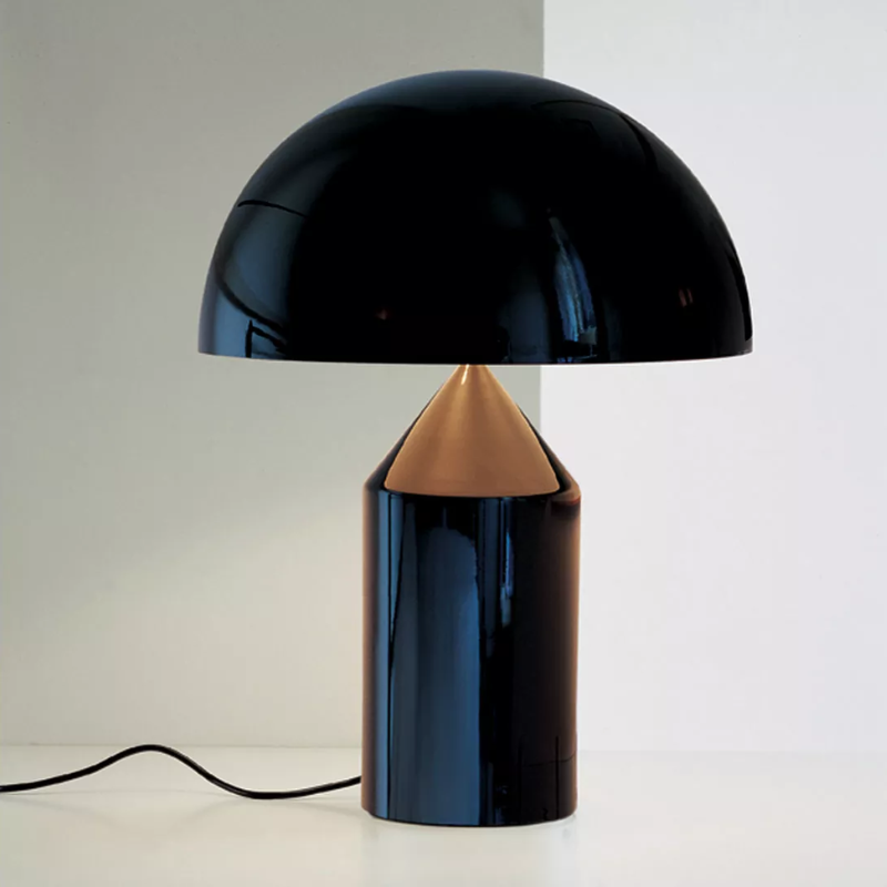 The Atollo Metal Table Lamp from Oluce in a family space.