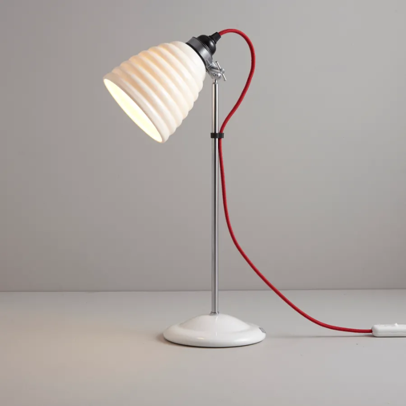 The Hector Bibendum Table Light from Original BTC in red in a living space.