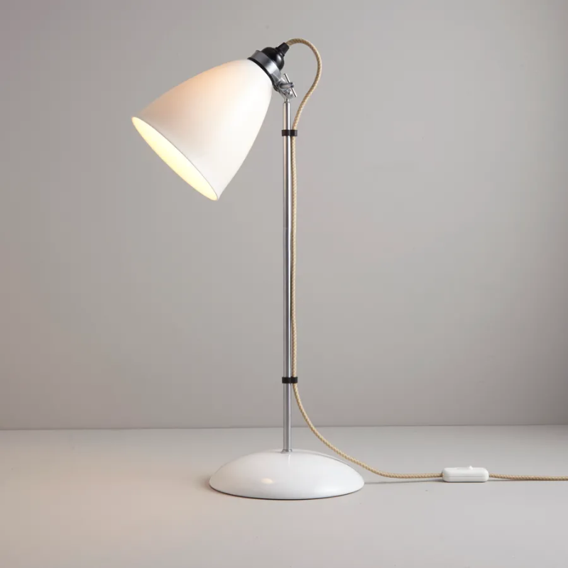 A British design classic in translucent Bone China. With its moveable shade and smart cotton braided cable, the Hector Table Light perfectly combines style and function. Available in three colors (natural white, light blue or light green) with varying sized shades.