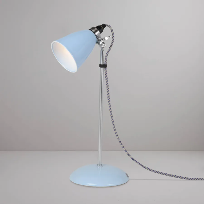 A British design classic in translucent Bone China. With its moveable shade and smart cotton braided cable, the Hector Table Light perfectly combines style and function. Available in three colors (natural white, light blue or light green) with varying sized shades.