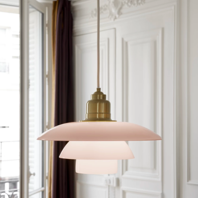 Inspired by Poul Henningsen’s fascination with the interplay between color and light, and the interior trends of today, the PH 3½-3 Pale Rose Brass Pendant features mouthblown pale rose-colored glass shades, which create a whimsical and poetic atmosphere in every room. The elegant expression is enhanced by the brushed brass detailing which, if left untreated, will patinate beautifully over time, giving the lamp character and charm.
