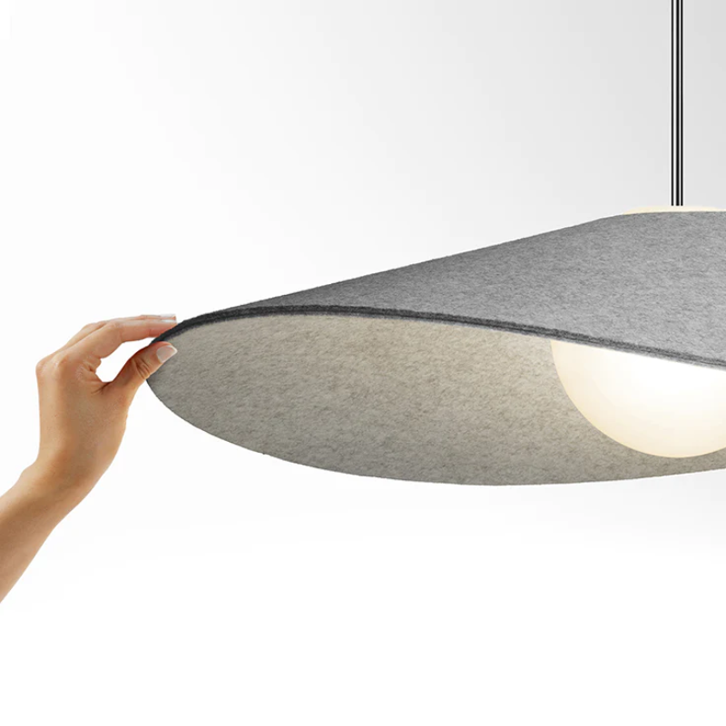 Bola Felt's shade rests elegantly over its opaline glass globe diffuser, allowing the user to tilt the shade to multiple angles to focus light. Bola’s thick felt shade also offers excellent acoustical properties, making them perfectly suited for use over dining applications as well as social gathering areas where sound control is beneficial.