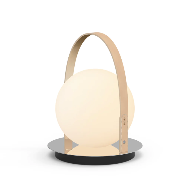 The Bola Lantern from Pablo Designs with the tan handle and chrome base.