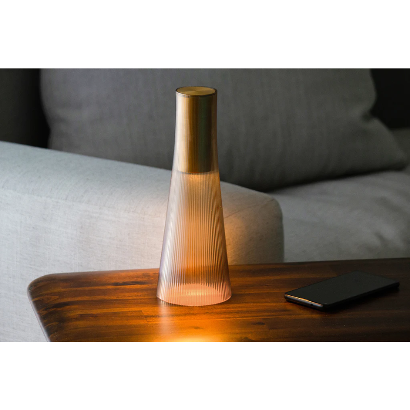 Inspired by a cone of light, Candél’s graceful vessel-like silhouette is in perfect harmony with its surroundings allowing the environment to filter through. Candél casts a warm, intimate candle-like glow that’s sure to seduce and become the central focus of any social gathering.