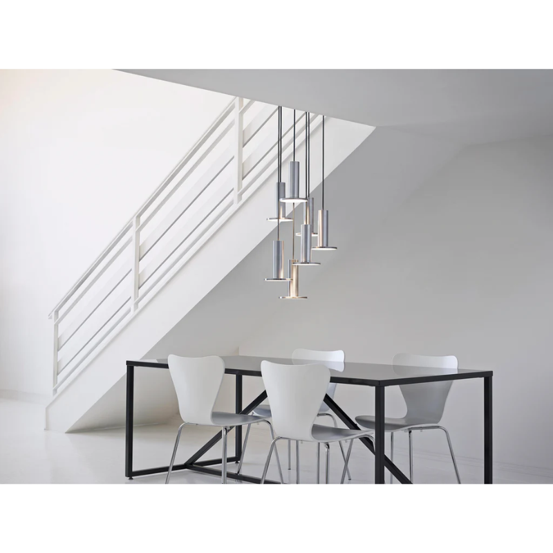 The Cielo Plus Chandelier from Pablo Designs hovering over a dining room table.