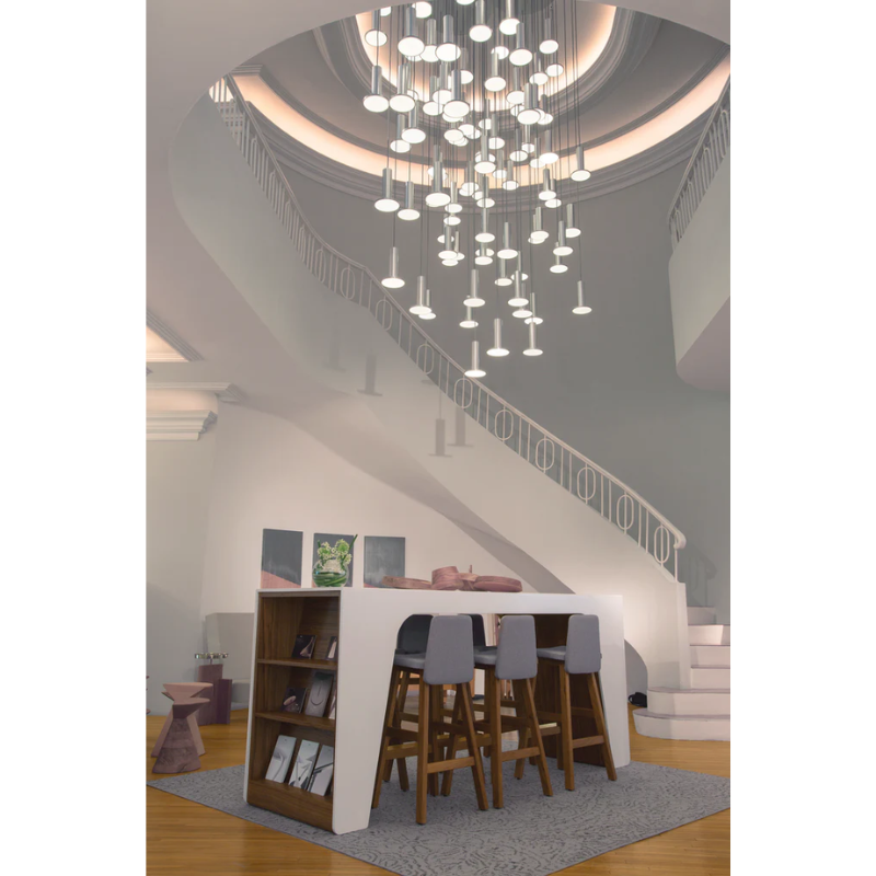 The Cielo Plus Chandelier from Pablo Designs above the table in a living room.