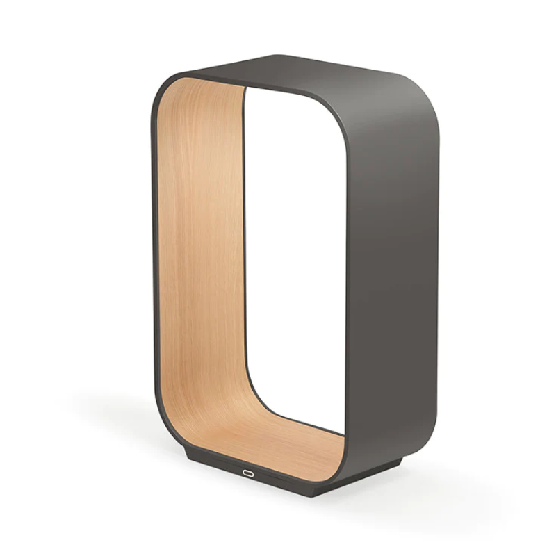 The small version of the Contour Table light from Pablo Designs in graphite and white oak.