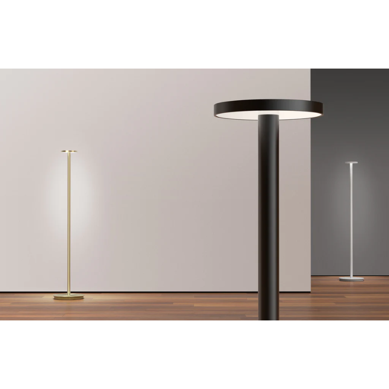 Three of the Luci Floor portable lights in an open space display room.