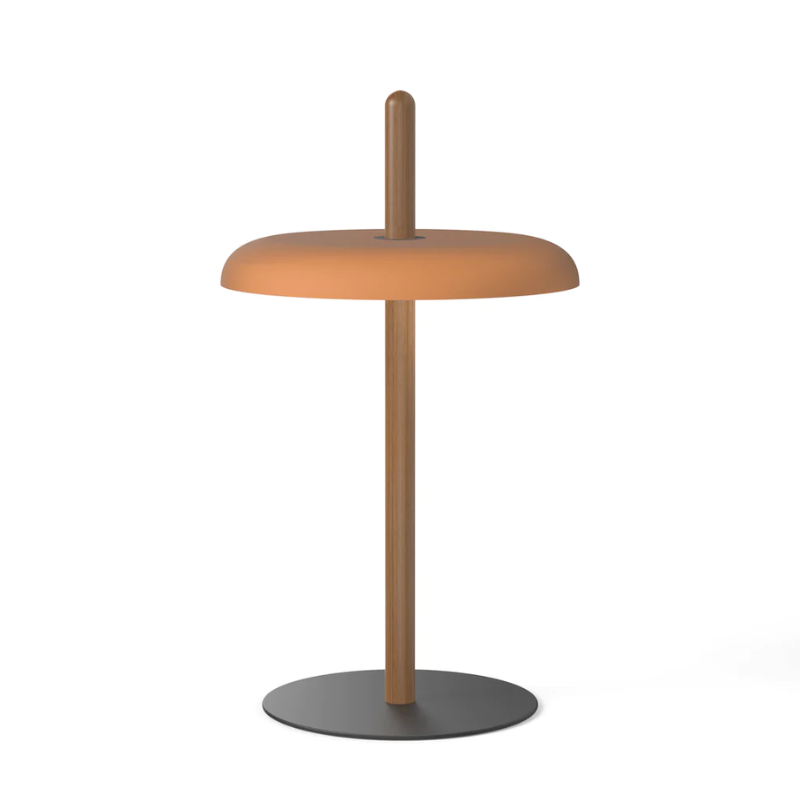 The Nivél Table from Pablo Designs with an walnut post and terracotta  shade.