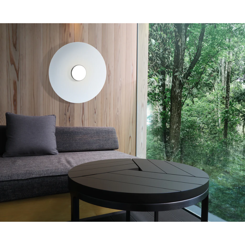 The Sky Dome Flush Metal from Pablo Designs in a living room above a sofa next to the window.