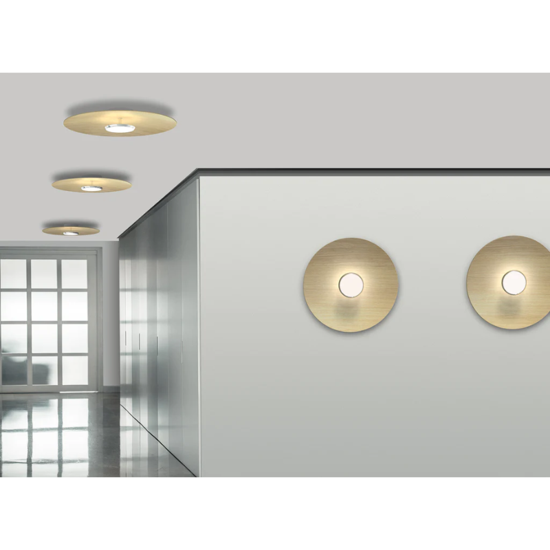 The Sky Dome Flush Wood from Pablo Designs mounted to the wall and ceiling in a hallway lifestyle shot.