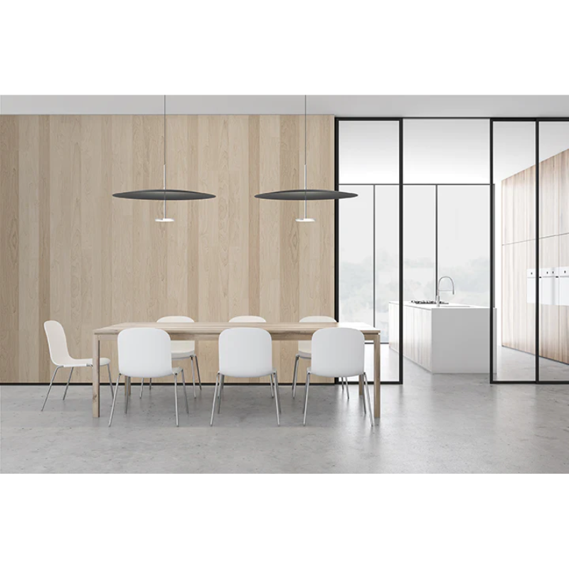 This image shows two Polished Aluminum and Black Sky Dome Metal pendant lights hanging from the ceiling above a dining room table next to the kitchen.