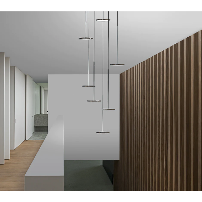 The Sky Solo from Pablo Designs comprising a chandelier in the hallway of a home.