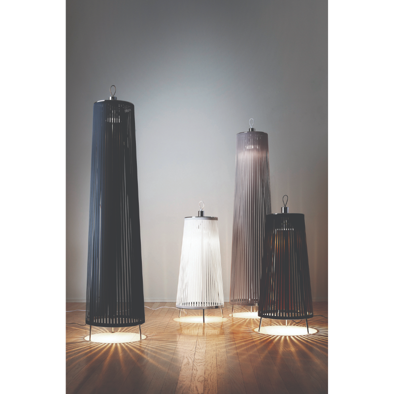 Four of the Solis Pendants from Pablo Designs on the floor in various shapes and colors.