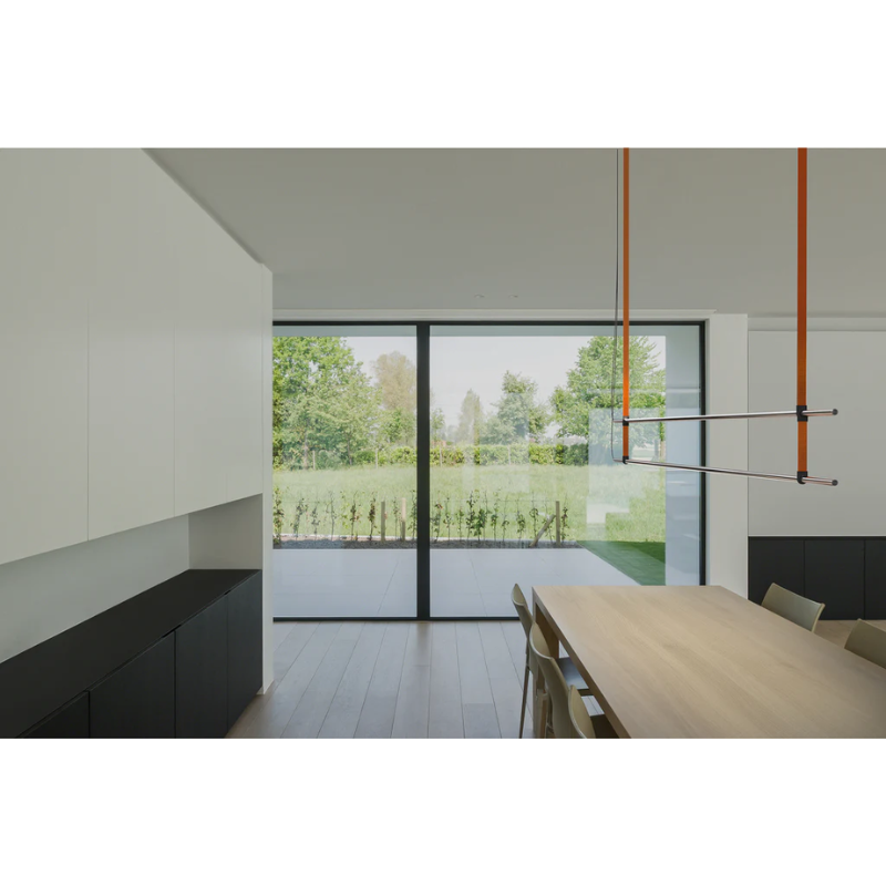 The T.O Pendant 2 Stack from Pablo Designs above the table in an open space kitchen and dining space.
