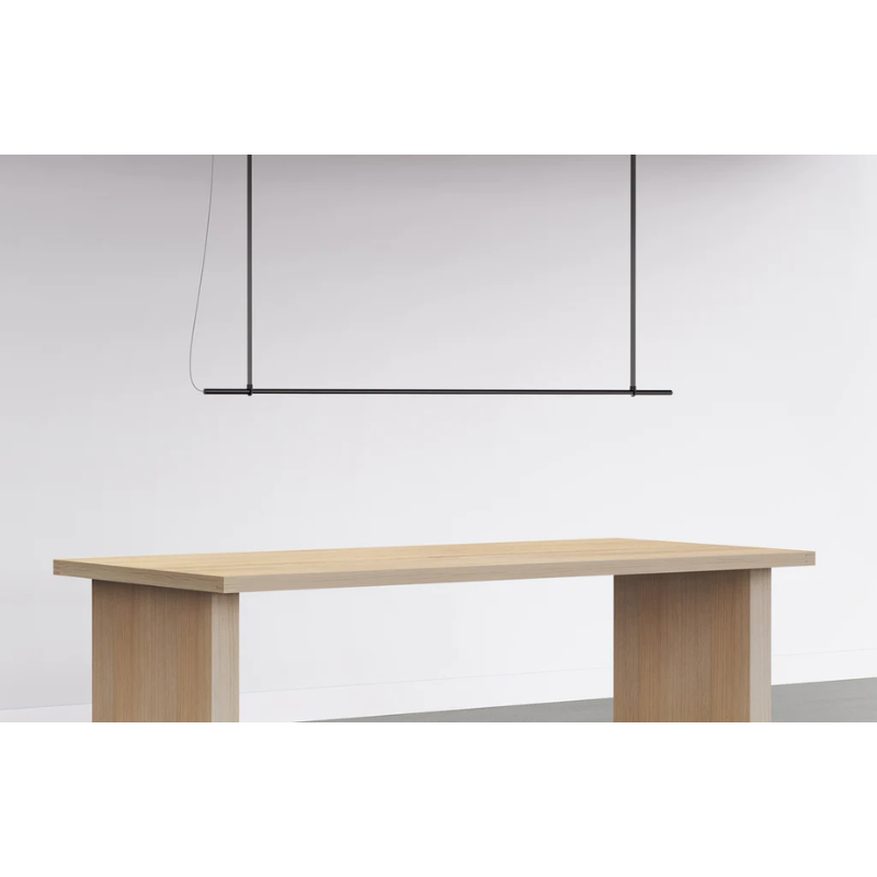 The T.O Pendant from Pablo Designs suspended above a display table.