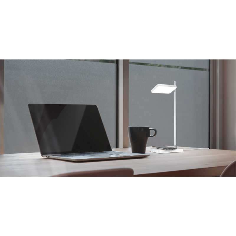 The Talia Table from Pablo Designs in a study area, charging a phone.