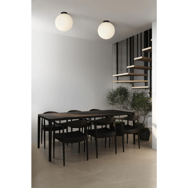 The Bola Sphere Flush from Pablo Designs in a dining room above a dining table.