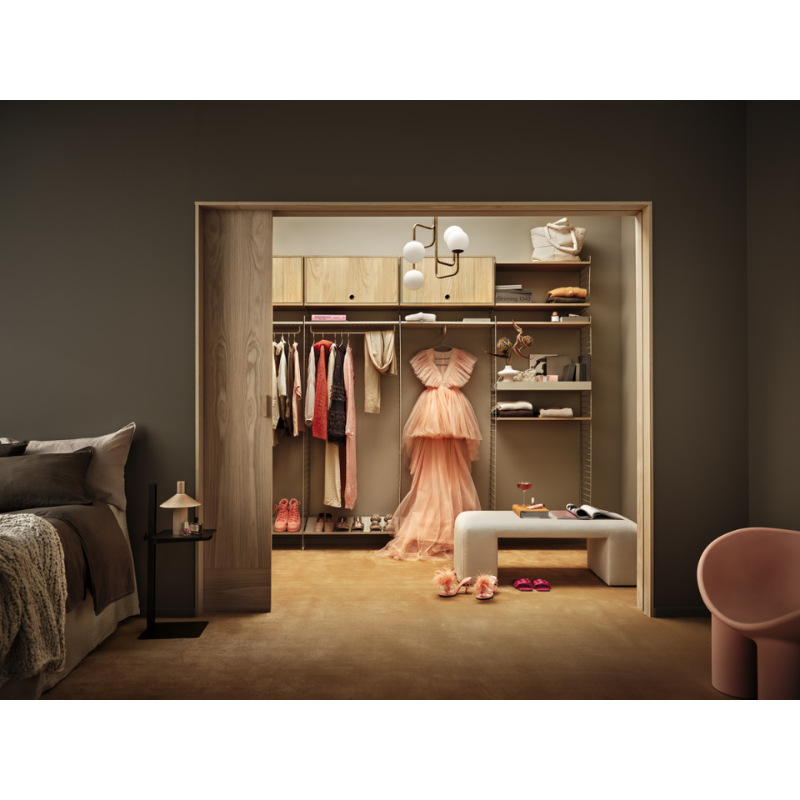 The Cabinet with Flip Door from String Furniture in a photograph showing them within a bedroom walk in closet.