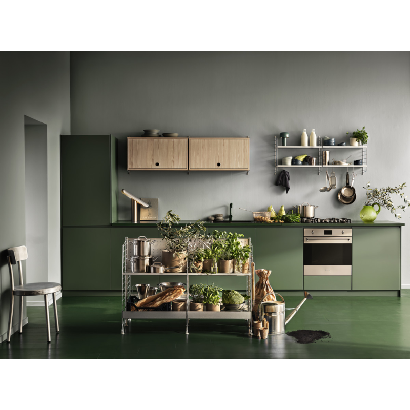 The Cabinet with Flip Door from String Furniture in a dining space.