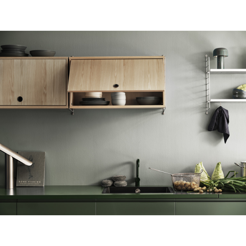 The Cabinet with Flip Door from String Furniture in a kitchen area.