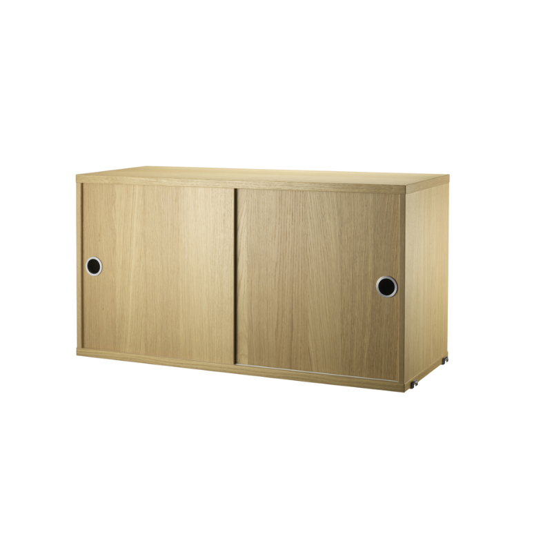 The Cabinet with Sliding Doors from String Furniture in the 11.8 inch depth size and oak color.