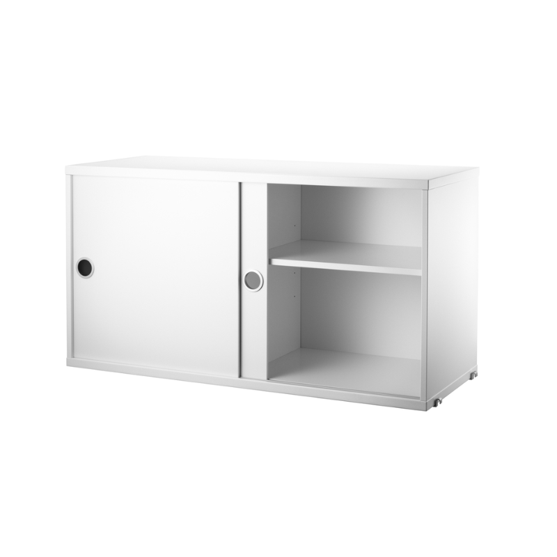 The Cabinet with Sliding Doors from String Furniture in a shot showing the internal storage.