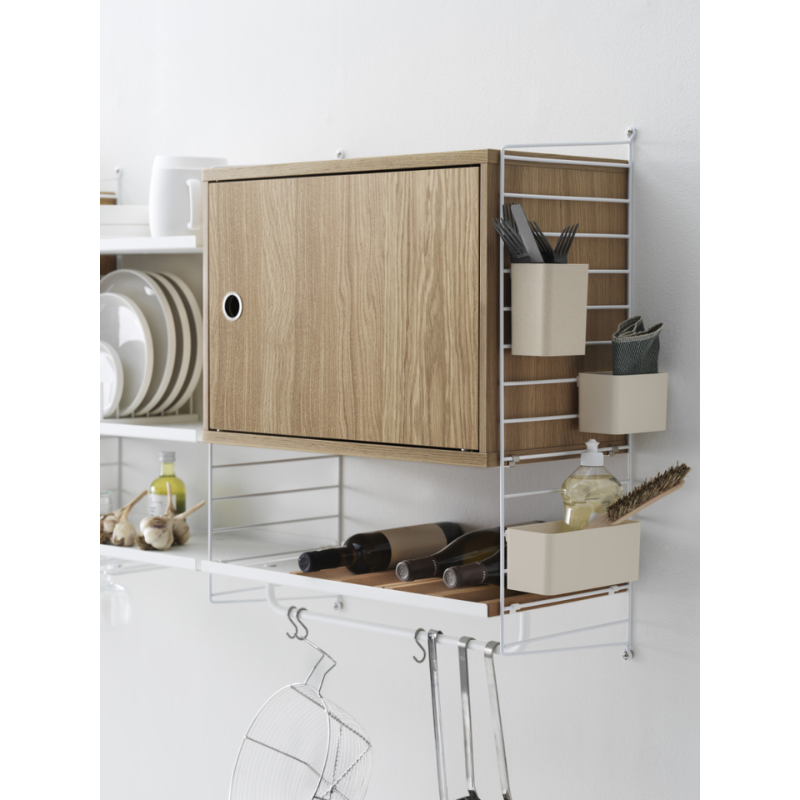 The Cabinet with Swing Door from String Furniture in a home lifestyle photograph.