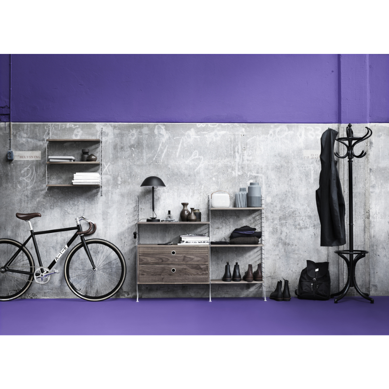 The Chest of Drawers from String Furniture in a garage.