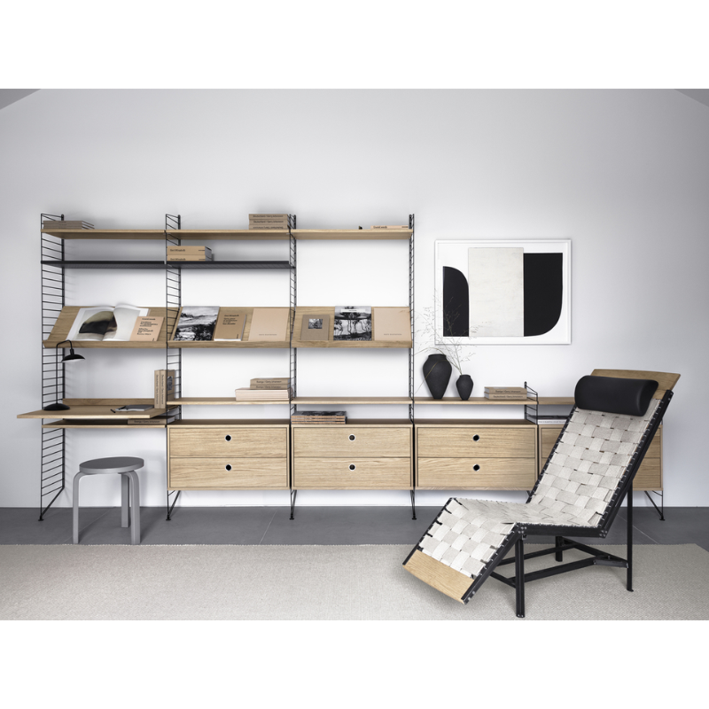 The Chest of Drawers from String Furniture in a library space.